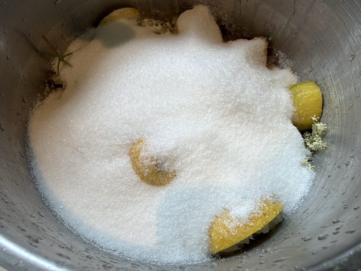 Hvis du har en quooker, så kom sukkeret direkte ned oven i og tilsæt så kogende vand bagefter. Ellers kog det op i en gryde ved siden af som nævnt i opskriften. opskrift på hjemmelavet hyldeblomstsaft hyldeblomst saft hjemmelavet hvordan laver man god måde